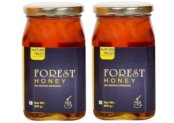 Drizzle of pure natural honey from a wooden dipper into a jar